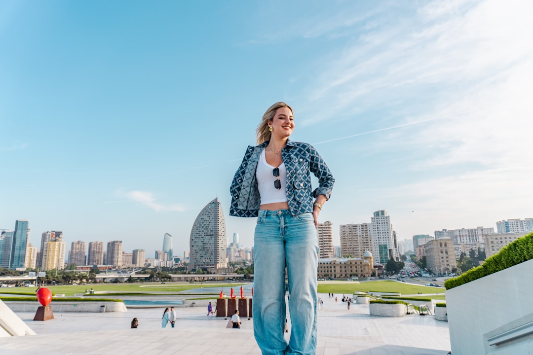Kancan Wide Leg Jeans - Woman standing on rooftop with city skyline behind her